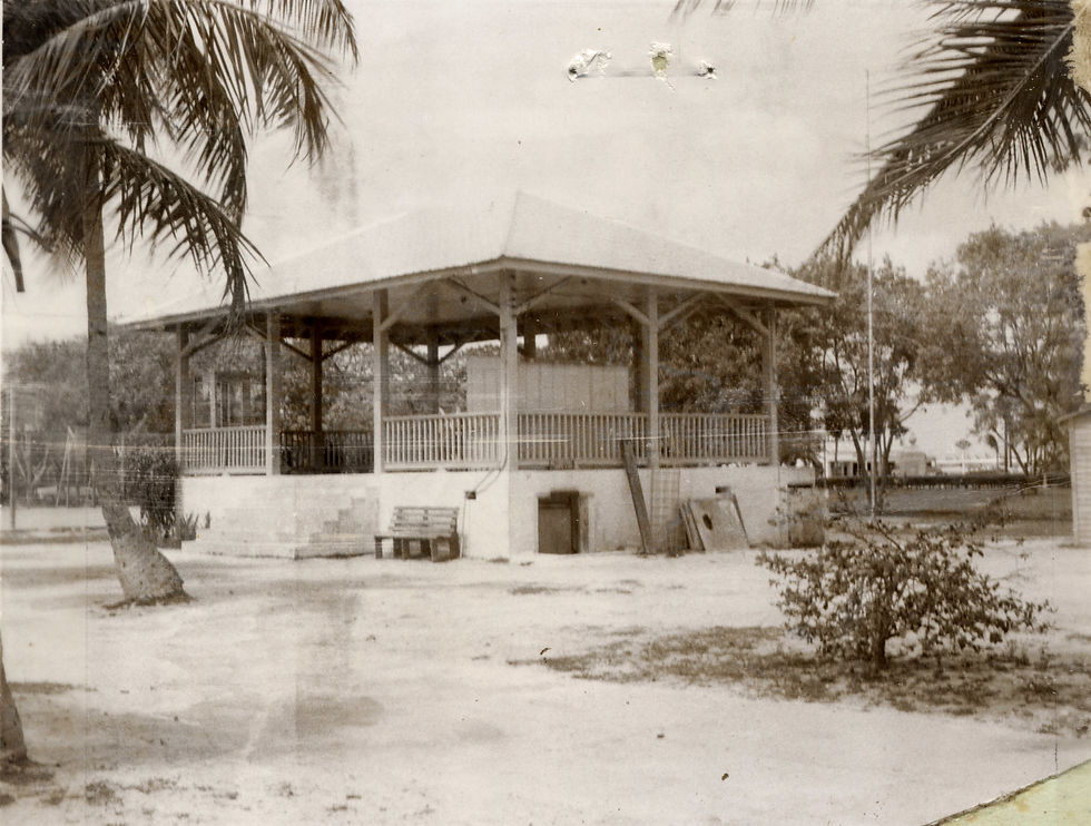 A bandstand in an open area with trees nearby.