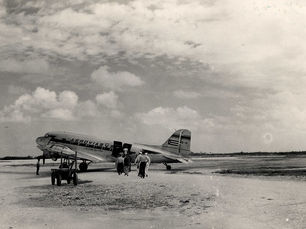 People walking toward a plane with AeroviasQ written on the side
