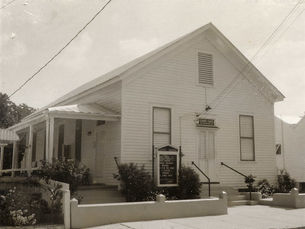 A small building with a sign over the door that reads Gospel Chapel