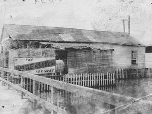A dilapidated building with a sign that reads The Turtle Kraals Key West