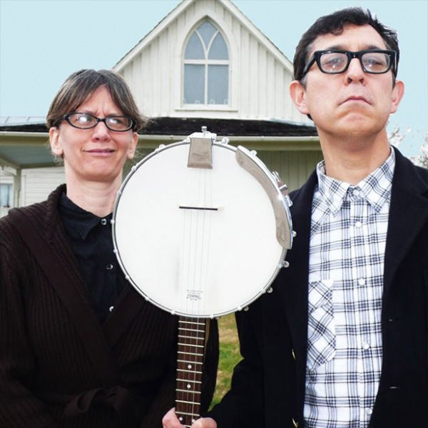 Two people with a banjo in a parody of the painting American Gothic