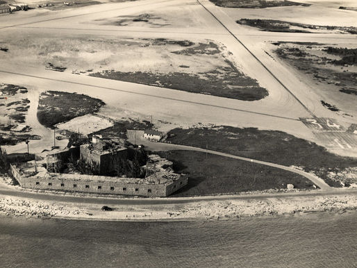 Aerial view of a shoreline with a fort and runways