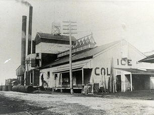 an industrial building with two smokestacks and the word ICE written on the side