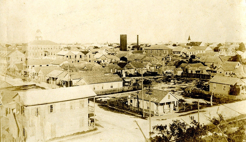 aerial view of a town with streets and one and two-story buildings