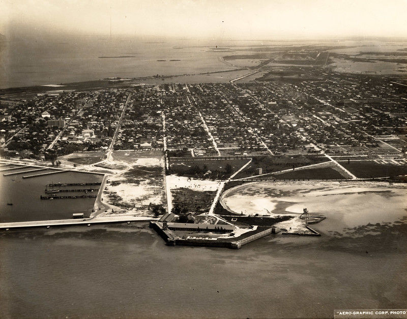 Aerial view of a developed island with a waterfront fort in the foregound.