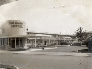 a two-story building with a sign that reads Blue Marlin Motel