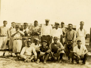 Two rows of people, some in baseball uniforms.