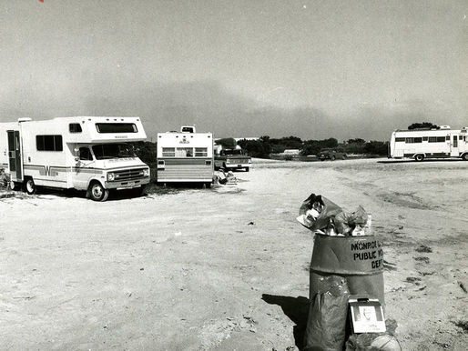 campers near an overflowing trash can