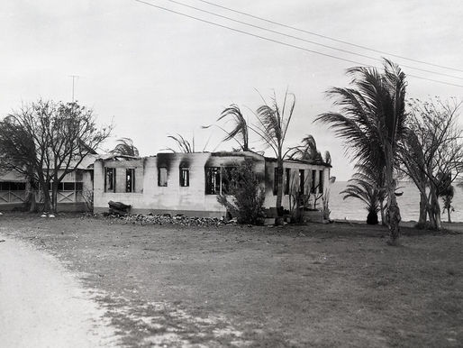 a burned out buildign with trees around it.