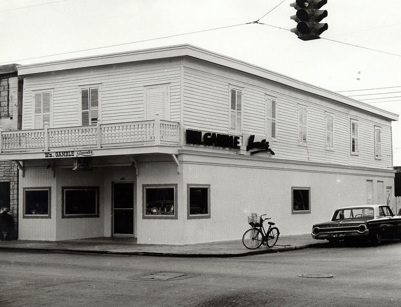 A building on a street corner with signs on the front and side reading Wm. Gamble Jeweler