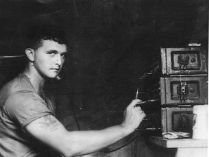 A young man with military radio equipment.