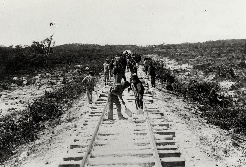 People working on a railroad bed.