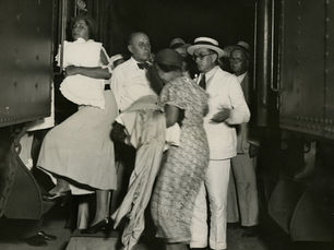 A group of people getting onto a train