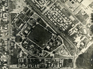 Aerial of a developed area with an open space in the center.