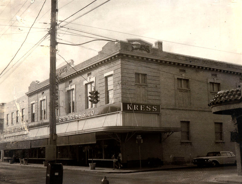 A large storefront on a corner with an awning and a sign that reads Kress