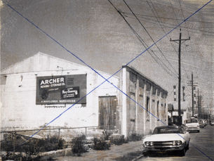 A building with a sign on the side that reads archer moving and storage.