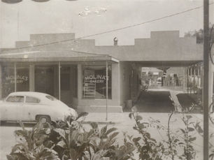 A storefront with Molina's Bakery written on the windows