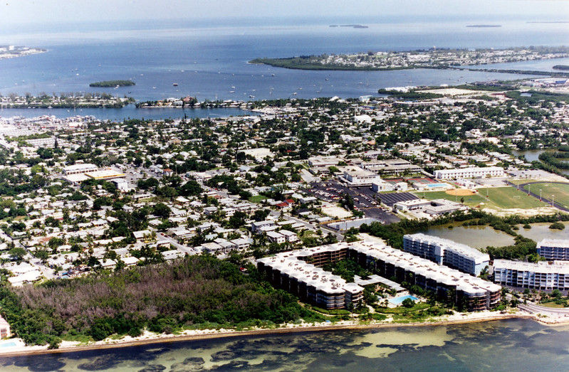 Aerial view of an island with an undeveloped area on the near shoreline.