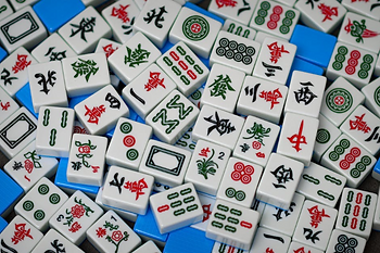 mahjong tiles on a blue surface