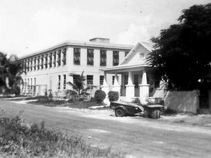 a house and large building with shutters on the windows