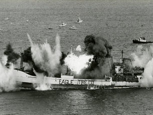 Explosions on a ship with Eagle Tire Co. written on the side