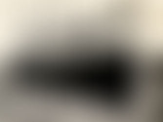 A large ship with olivette written on the side tied up at a dock.