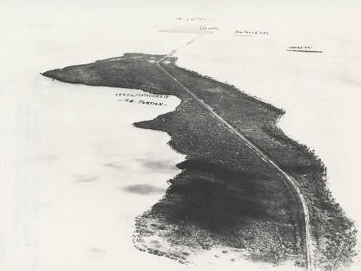 Aerial view of an island with a road going through it.