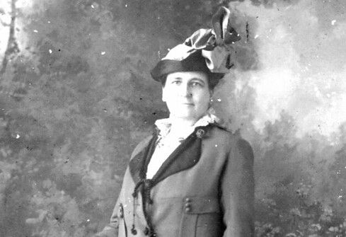 A woman standing next to a chair