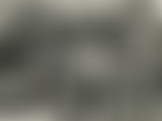 A man stands next to a furled sail on the deck of a sailboat