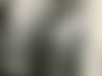 Four people sitting and standing on a porch