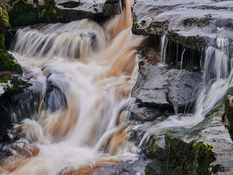 Water crashing over rocks on a waterfall in the Yorkshire Dales