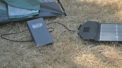 Thumbnail: Portable Outlet Battery shown being charged with solar panel