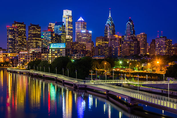 The Philadelphia skyline and Schuylkill River at night, seen from the South Street Bridge