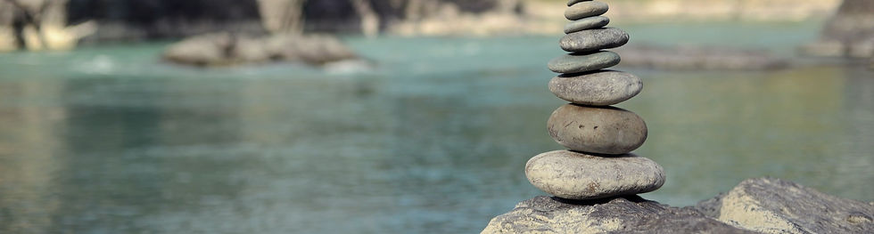 beach scene with stack of rocks in the foregroung