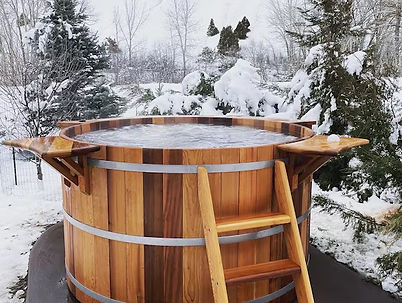 Outdoor hot tub surrounded by natural wood decking, offering a relaxing Canadian-made wellness experience
