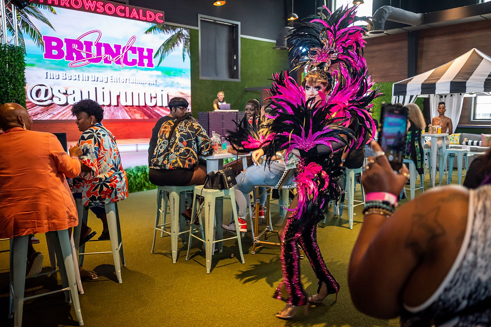SADBrunch drag performance with the SADBrunch stage backdrop