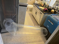 dehumidifier blowing ducted air in water damage room