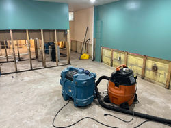 flooded basement with removed drywall and floors after a water damage
