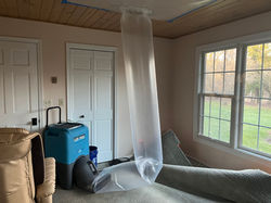 ducted dehumidifier into exposed ceiling cavity drying after a roof leak that caused water
