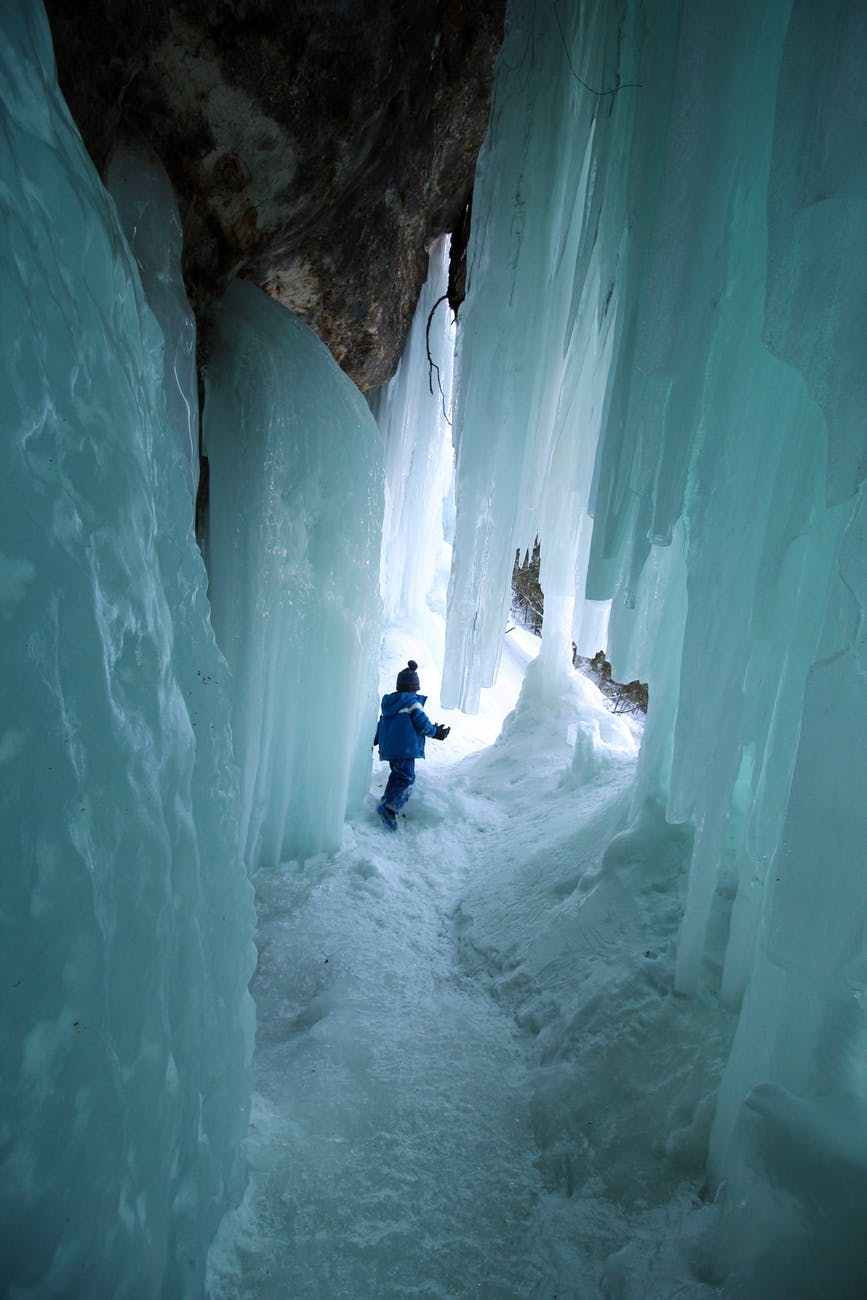 kid playing in a cave with snow