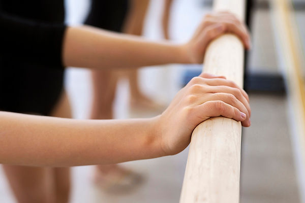 Student hands on a ballet bar