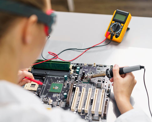 high-angle-female-technician-with-soldering-iron-electronics-motherboard.jpg