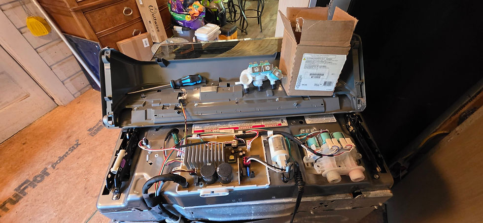 disassembled whirlpool top-load washer with parts and wires showing