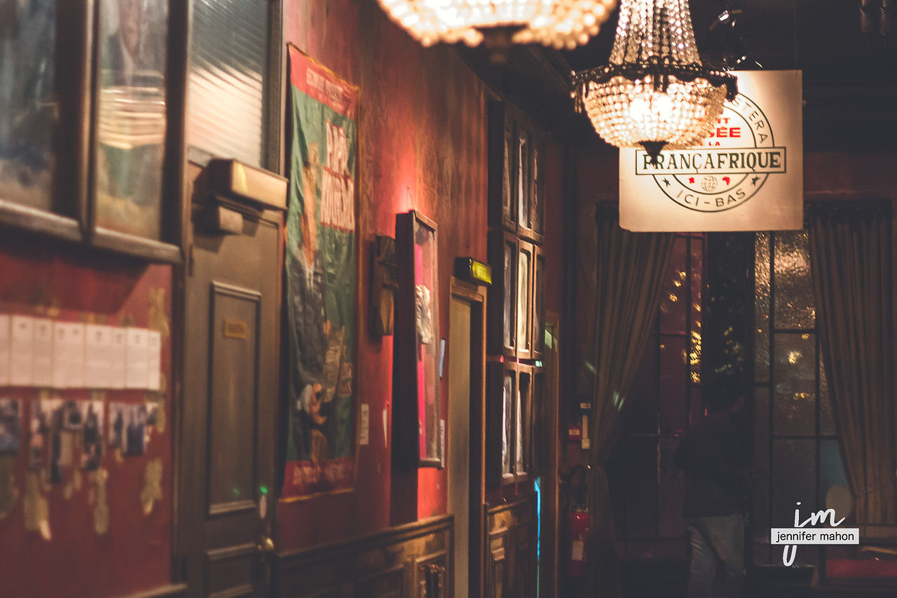 Le Comptoir Général - hallway with paintings on the wall