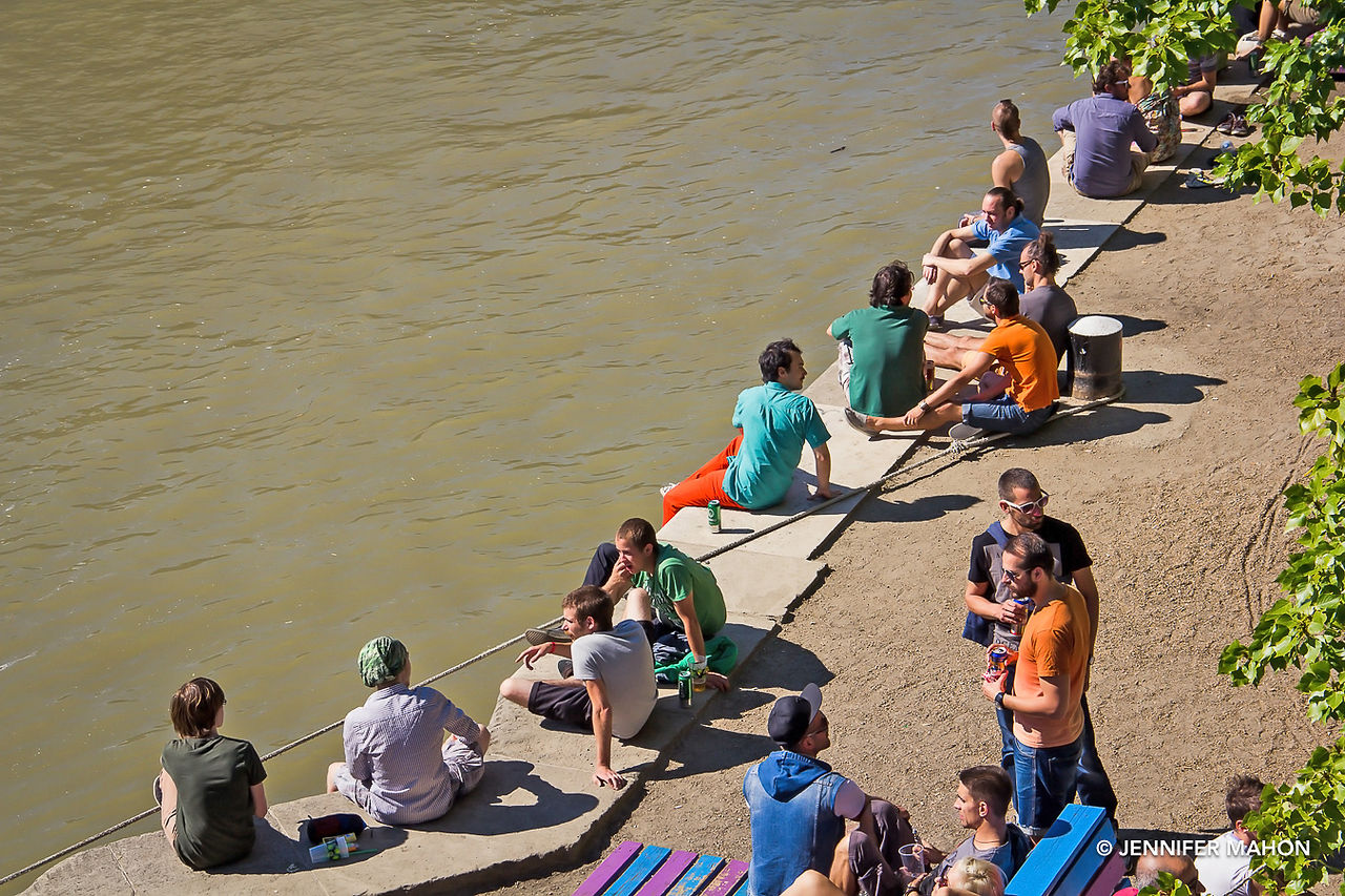 People chillin' by the Danube on a sunny afternoon
