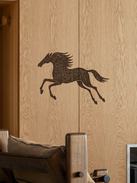 Galloping horse silhouette on wood wall