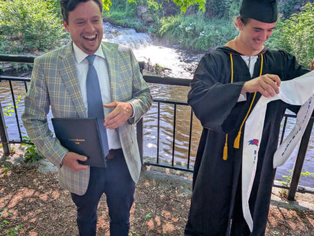 Scott Ireland, Hyde School faculty member and parent, in the foreground at his son Liam’s 2025 college commencement — reflecting Hyde School’s multigenerational impact.