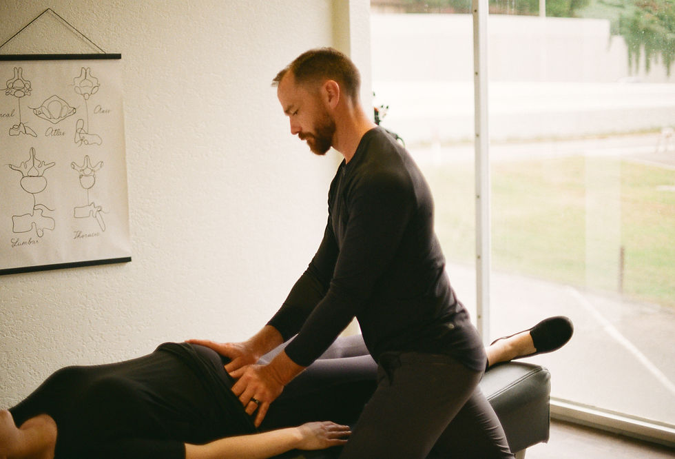 Knoxville chiropractor gently adjusts a pregnant woman.
