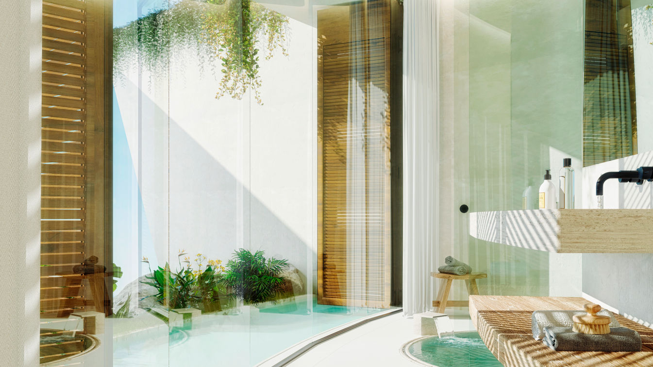 Moderno baño con una amplia zona de ducha de cristal, abundante luz natural y plantas verdes. El diseño presenta una combinación de texturas y materiales como madera, vidrio y azulejos. Hay una sensación de tranquilidad y amplitud debido a la presencia de vegetación y la distribución espaciosa. Se muestran tendencias contemporáneas de diseño de interiores que enfatizan elementos naturales, luz y estética minimalista.