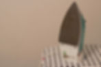 Clothes_iron_on_ironing_board.jpeg